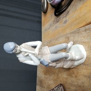 Lladro flute boy retired by casades. Beautiful measures 9 1/4" tall. No cracks